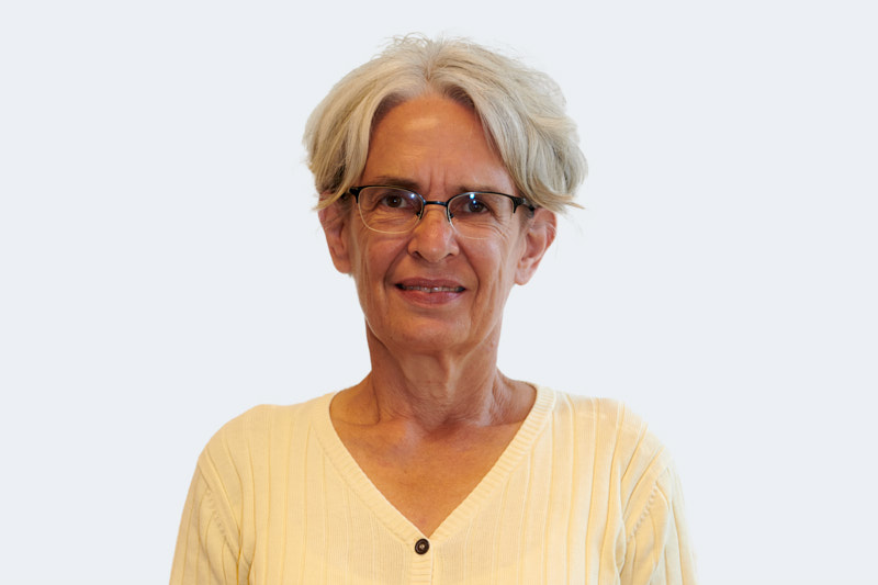 smiling woman in white and black checkered dress shirt