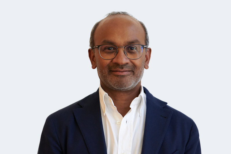 smiling woman in white and black checkered dress shirt